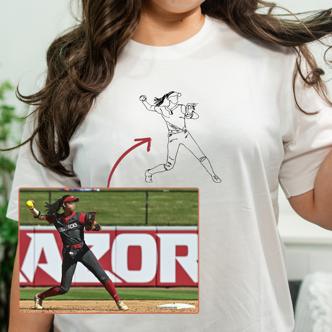A woman wearing a custom-designed white t-shirt with a softball player designed from an original photo.