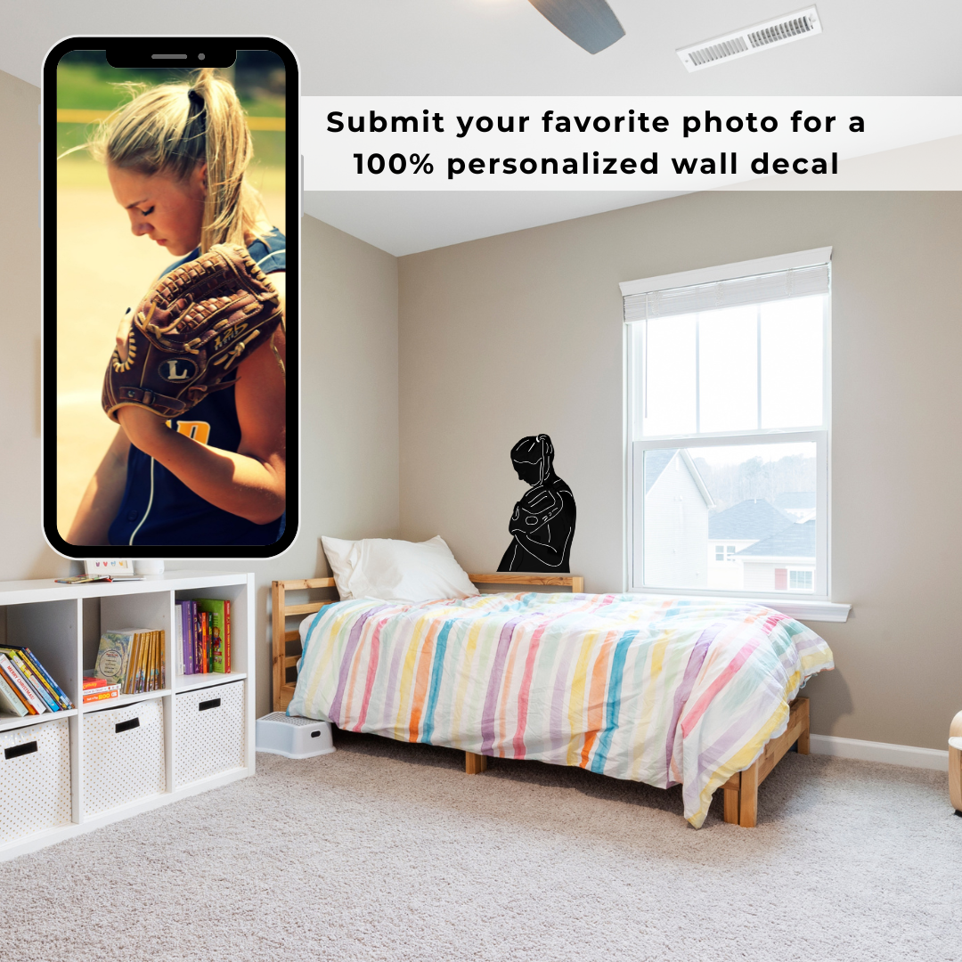 A girl's bedroom with a custom decal of a softball player silhouette and text that reads 'Submit your favorite photo for a 100% personalized wall decal.'