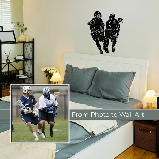 A black custom-made vinyl wall decal of two running lacrosse players is displayed above a bed with blue sheets and pillow covers.
